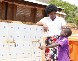 a teacher and student washing hands